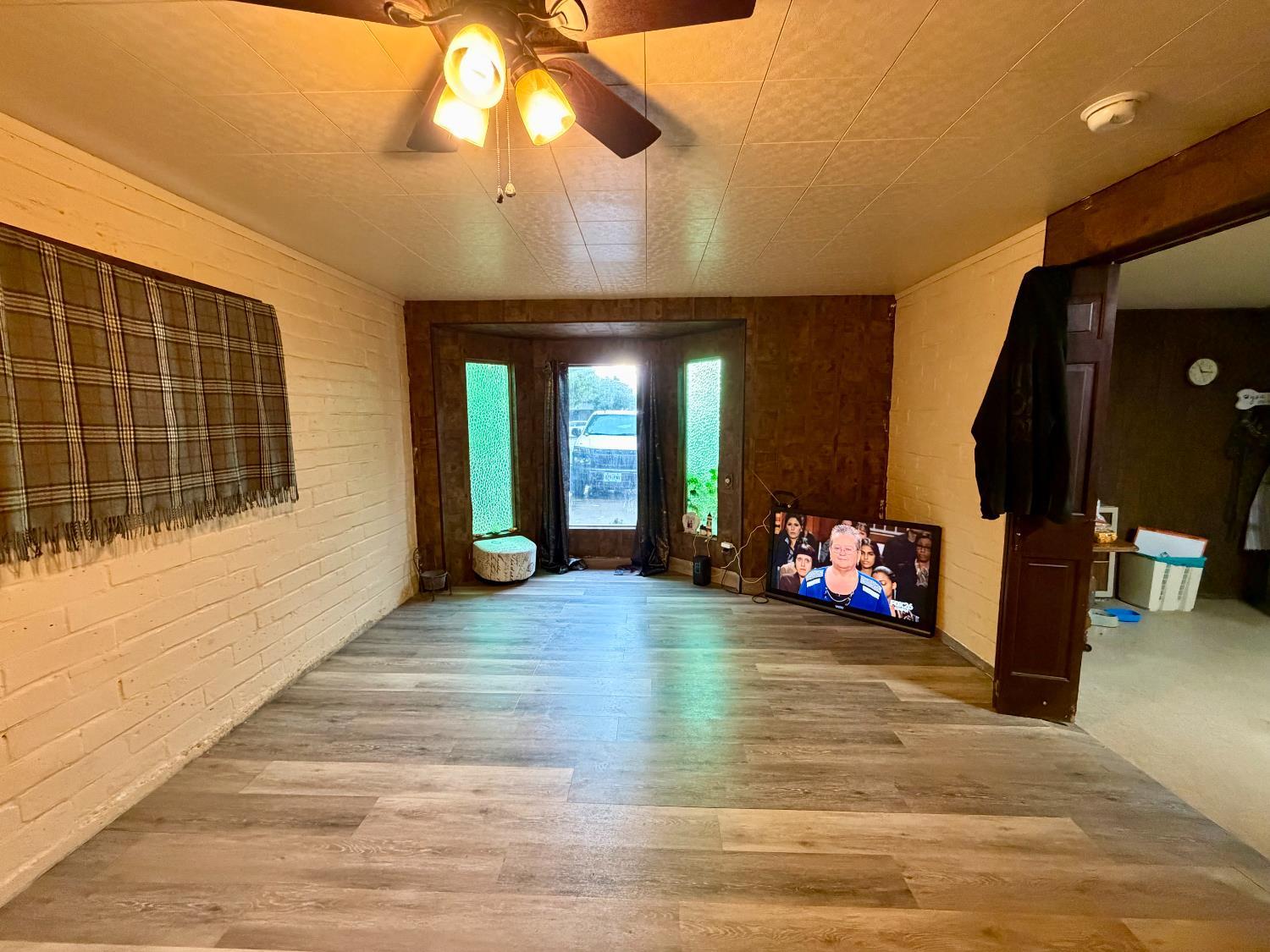 313 South K Street Madera, CA 93637 - Photo 13 of 19 a view of a livingroom with a hall and furniture