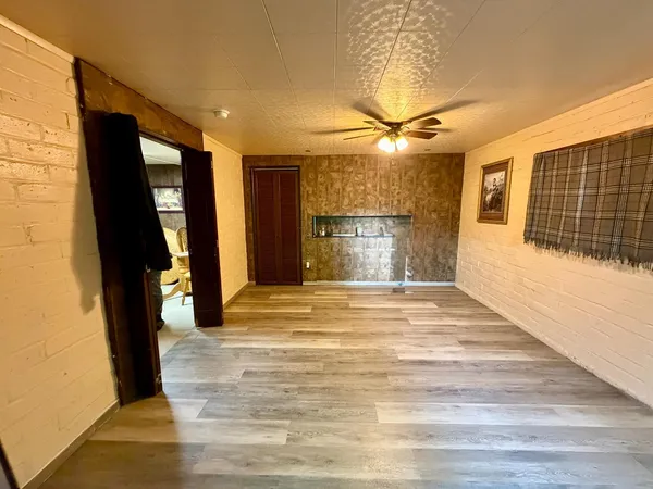 a view of empty room with a fireplace and chandelier