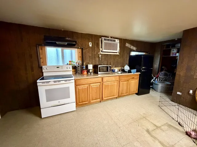 a kitchen with a stove a sink and a refrigerator