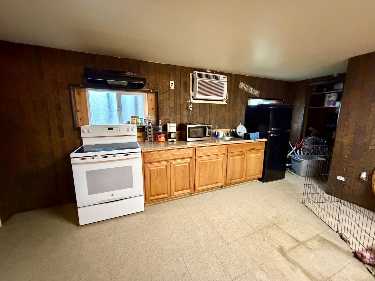 313 South K Street Madera, CA 93637 - Photo 15 of 19 a kitchen with a stove a sink and a refrigerator