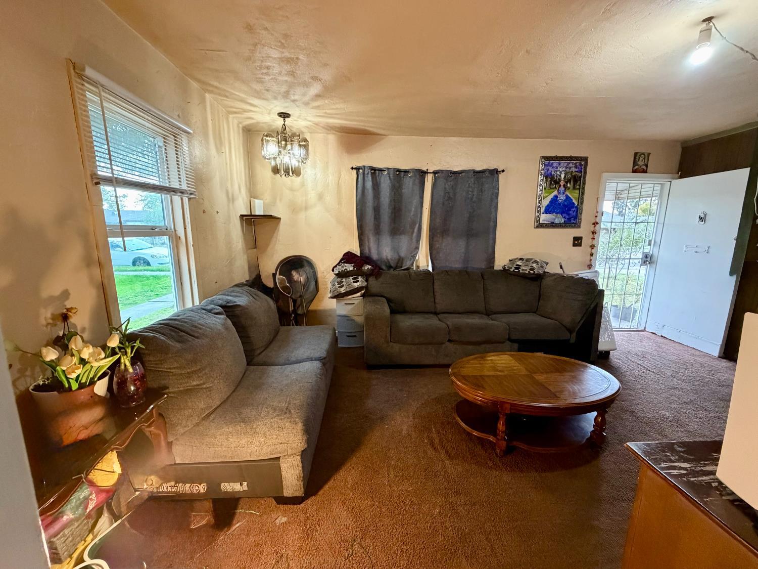 313 South K Street Madera, CA 93637 - Photo 3 of 19 a living room with furniture and a window