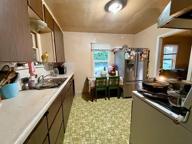 a kitchen with a sink appliances and cabinets