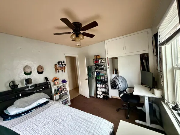 a view of a workspace with furniture and a window