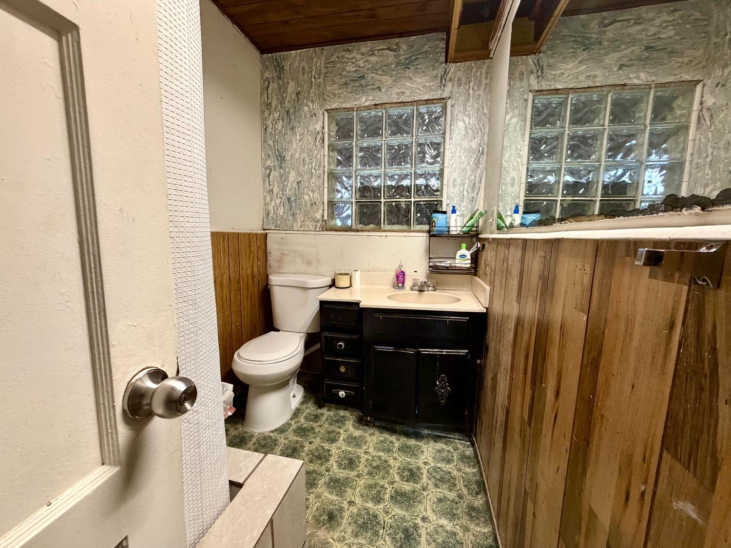 313 South K Street Madera, CA 93637 - Photo 7 of 19 a bathroom with a sink toilet and window