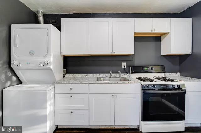 a kitchen with a stove and white cabinets