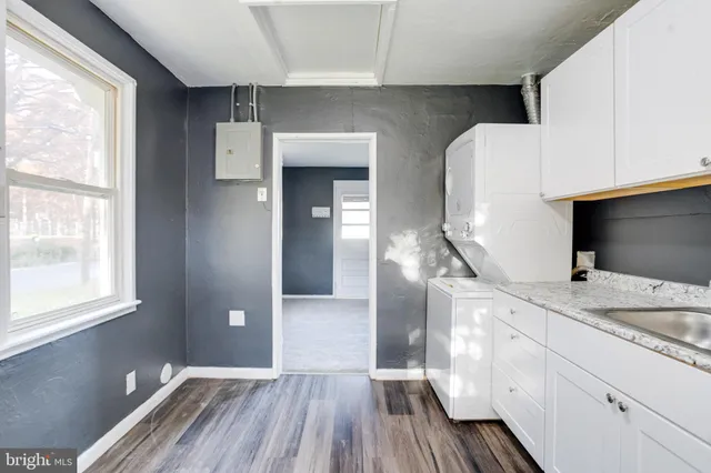 a spacious bathroom with a granite countertop sink and a mirror