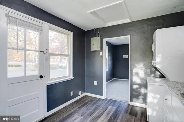 a view of hallway with a large window and wooden floor