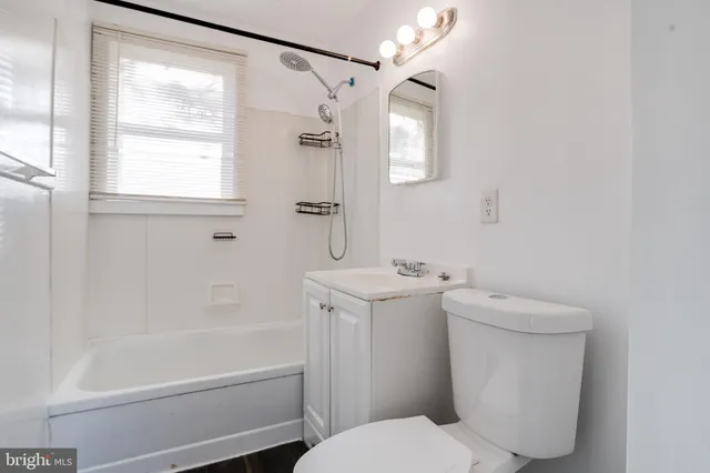 a bathroom with a sink vanity tub and shower