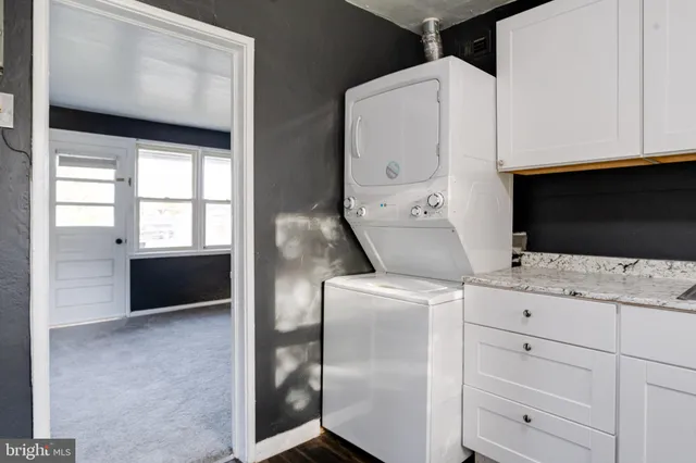 a view of a house with a yard patio and fire pit