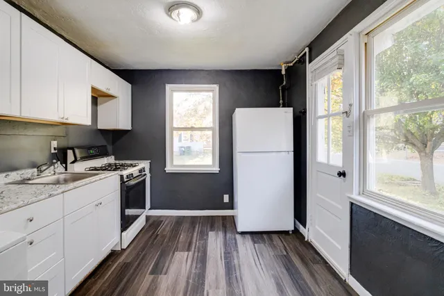 a kitchen with a refrigerator and a sink