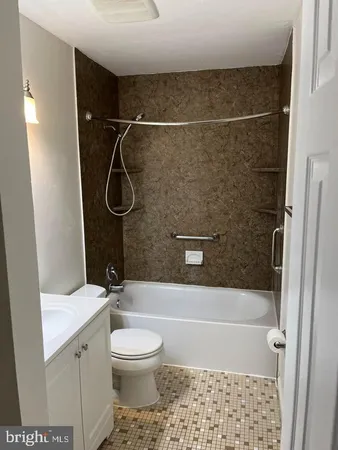 a bathroom with a shower a toilet and sink