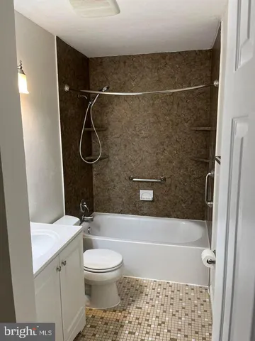a bathroom with a shower a toilet and sink