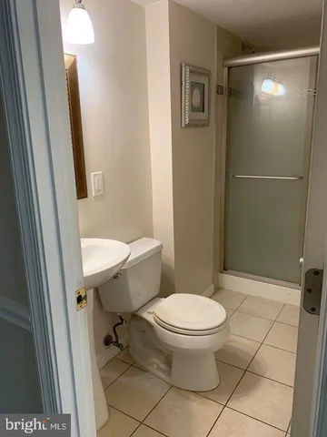 a white toilet sitting next to a bathroom sink