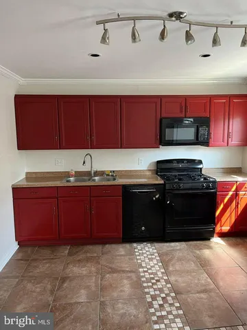a kitchen with granite countertop a stove and a refrigerator