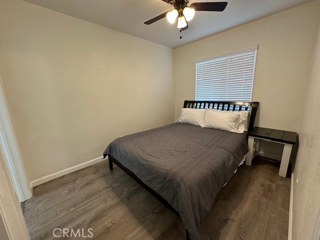 211 South Spring Street Blythe, CA 92225 - Photo 2 of 5 a bedroom with a bed and a chandelier