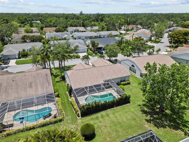 an aerial view of a house with a yard
