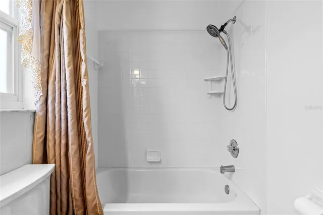 a bathroom with a sink a mirror and shower