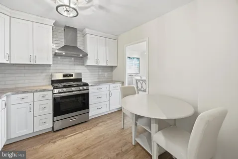 a kitchen with stainless steel appliances a refrigerator sink and cabinets