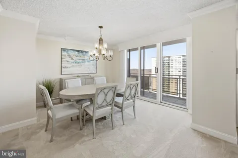 a view of a dining room with furniture and chandelier