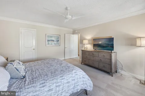 a bedroom with a bed a window and a television