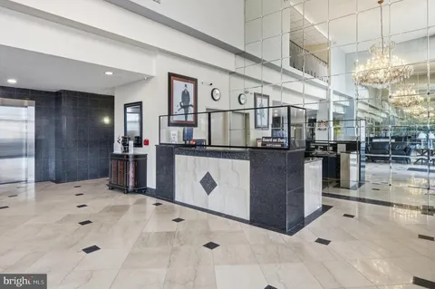 a kitchen with stainless steel appliances kitchen island granite countertop a refrigerator and a stove
