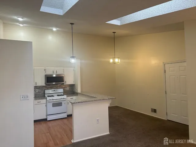 a kitchen with a refrigerator and a stove top oven