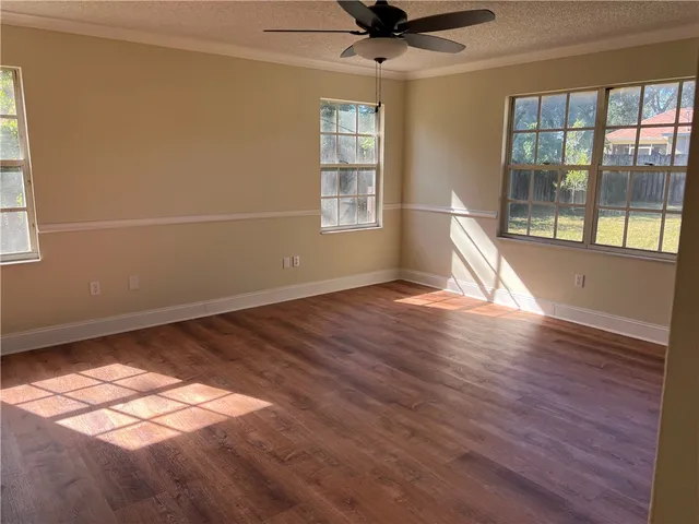 a view of a livingroom with wooden floor and a window