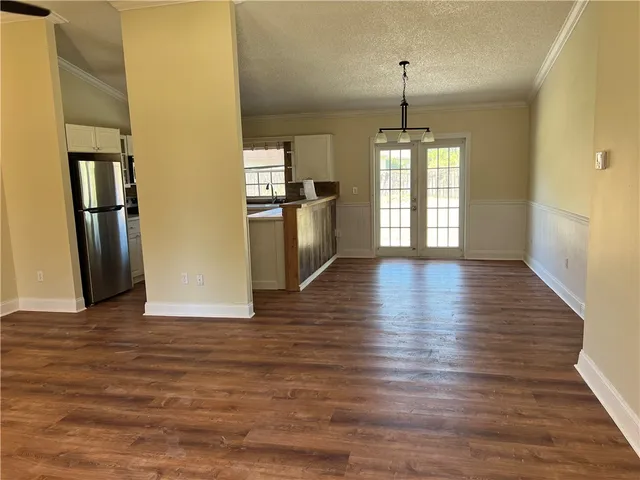a view of a room with wooden floor and windows