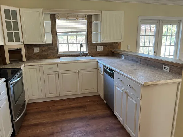 a kitchen with a sink stove and cabinets