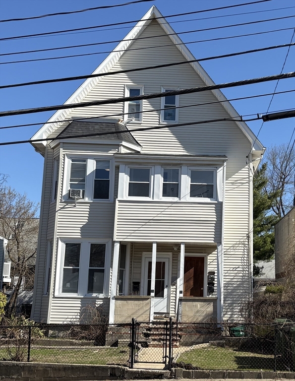 73 Nichols Avenue, Unit 2 Watertown, MA 02472 - Photo 1 of 9 a front view of a house with garage