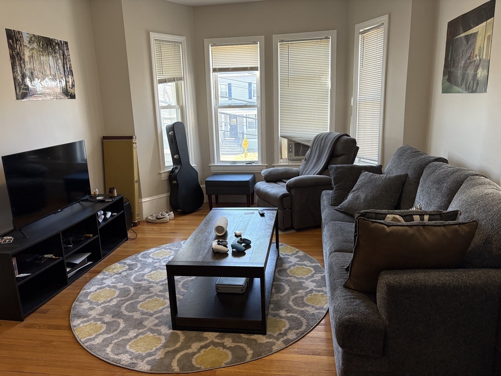 73 Nichols Avenue, Unit 2 Watertown, MA 02472 - Photo 2 of 9 a living room with furniture and a flat screen tv