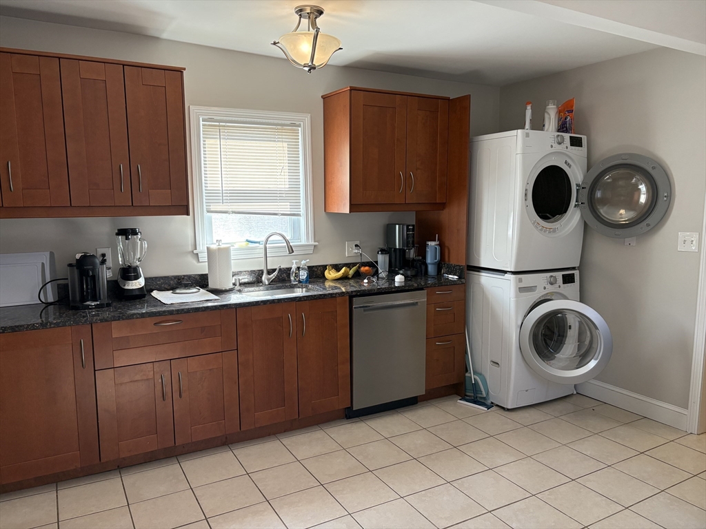 73 Nichols Avenue, Unit 2 Watertown, MA 02472 - Photo 3 of 9 a view of a kitchen with washer and dryer