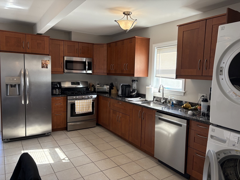 73 Nichols Avenue, Unit 2 Watertown, MA 02472 - Photo 4 of 9 a kitchen with stainless steel appliances granite countertop a stove a sink dishwasher a refrigerator and a microwave