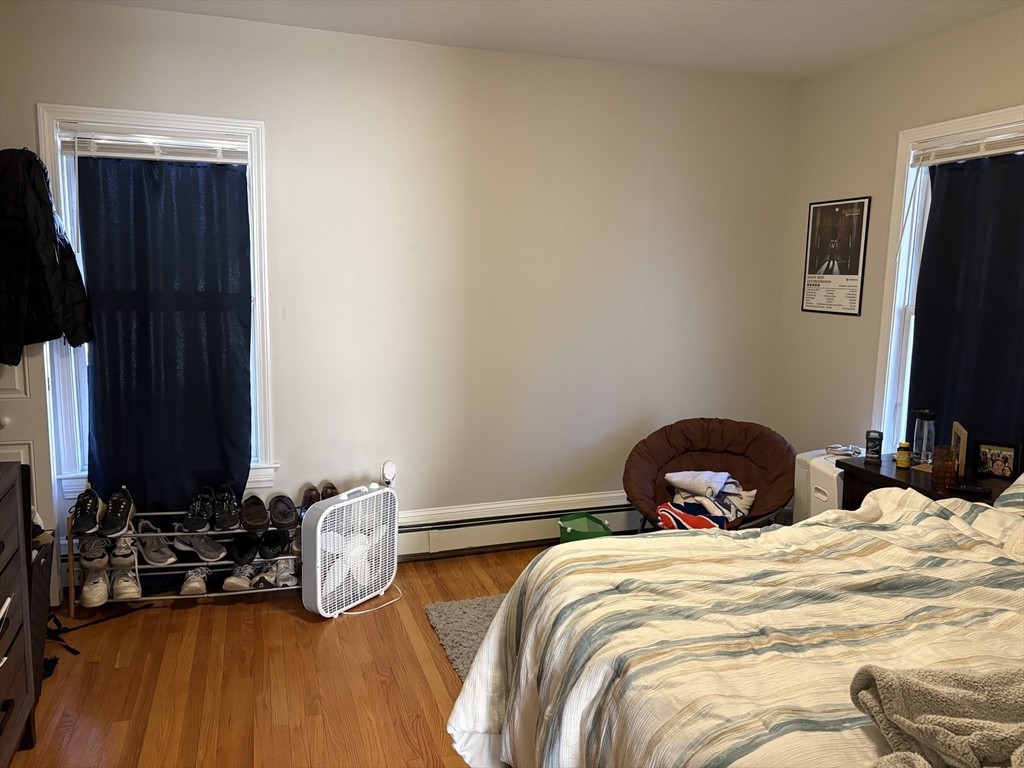 73 Nichols Avenue, Unit 2 Watertown, MA 02472 - Photo 5 of 9 a bedroom with two beds and a flat screen tv