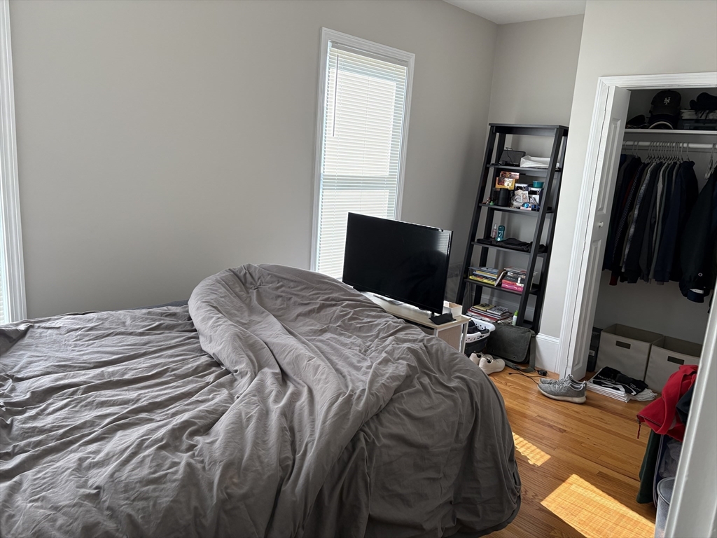 73 Nichols Avenue, Unit 2 Watertown, MA 02472 - Photo 6 of 9 a bedroom with a bed and a flat screen tv