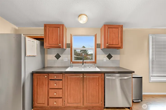 a kitchen with granite countertop a sink and cabinets