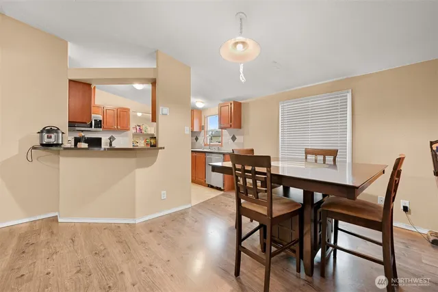 a view of a dining room with furniture and a large window