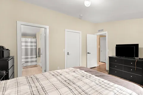 a bedroom with a bed and a flat screen tv