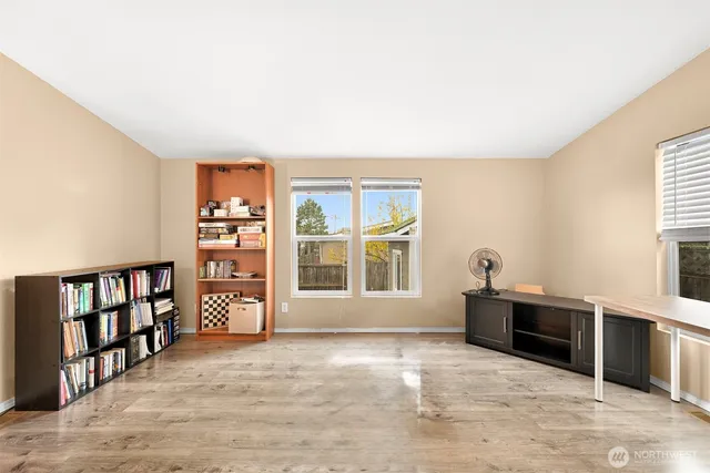 a view of an empty room with a window and cabinet
