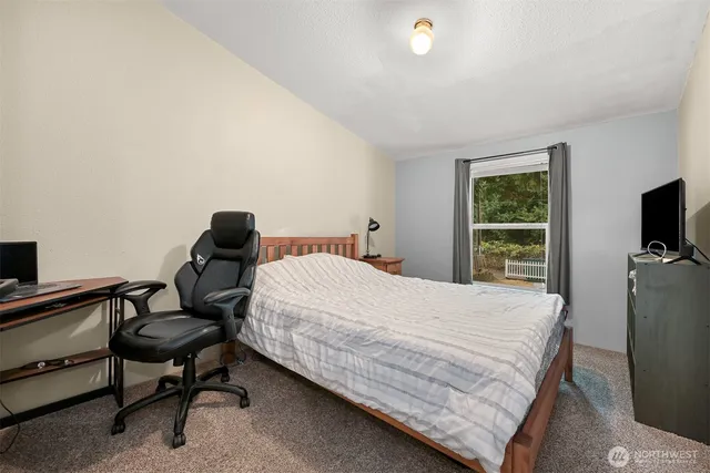 a bedroom with a bed and a chair