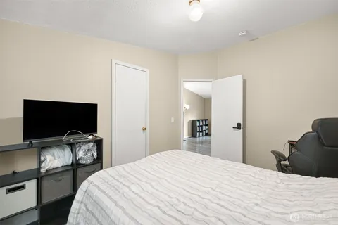 a bedroom with a bed and a flat screen tv