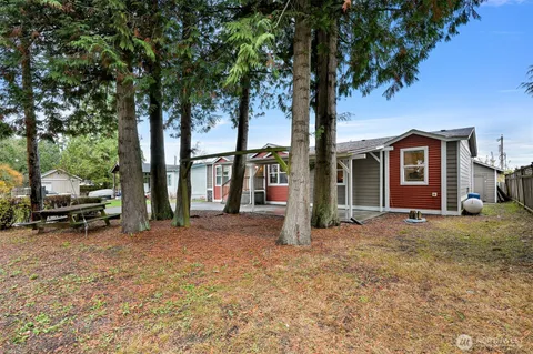 a view of a house with a patio and a yard