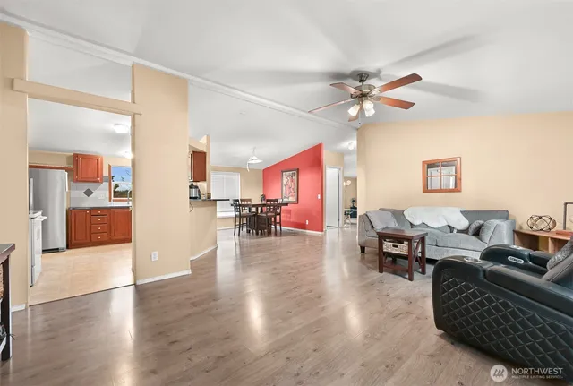 a living room with furniture and wooden floor