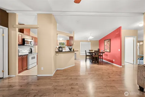 a view of a kitchen with furniture and refrigerator