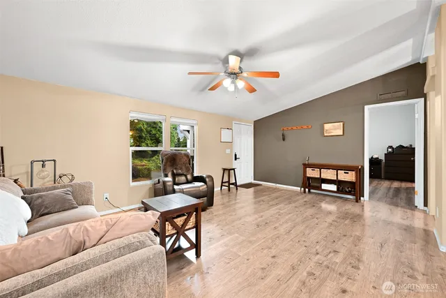 a living room with furniture and a chandelier