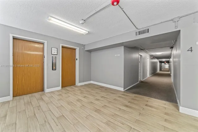 a room with white cabinets and white appliances