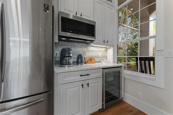 a kitchen with white cabinets stainless steel appliances and sink