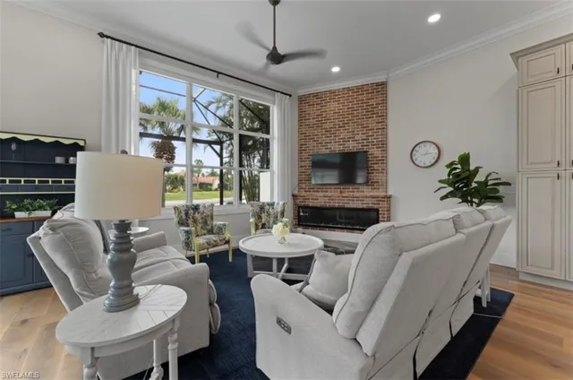 a living room with furniture potted plant and a large window