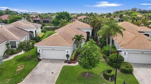 an aerial view of a house with a yard