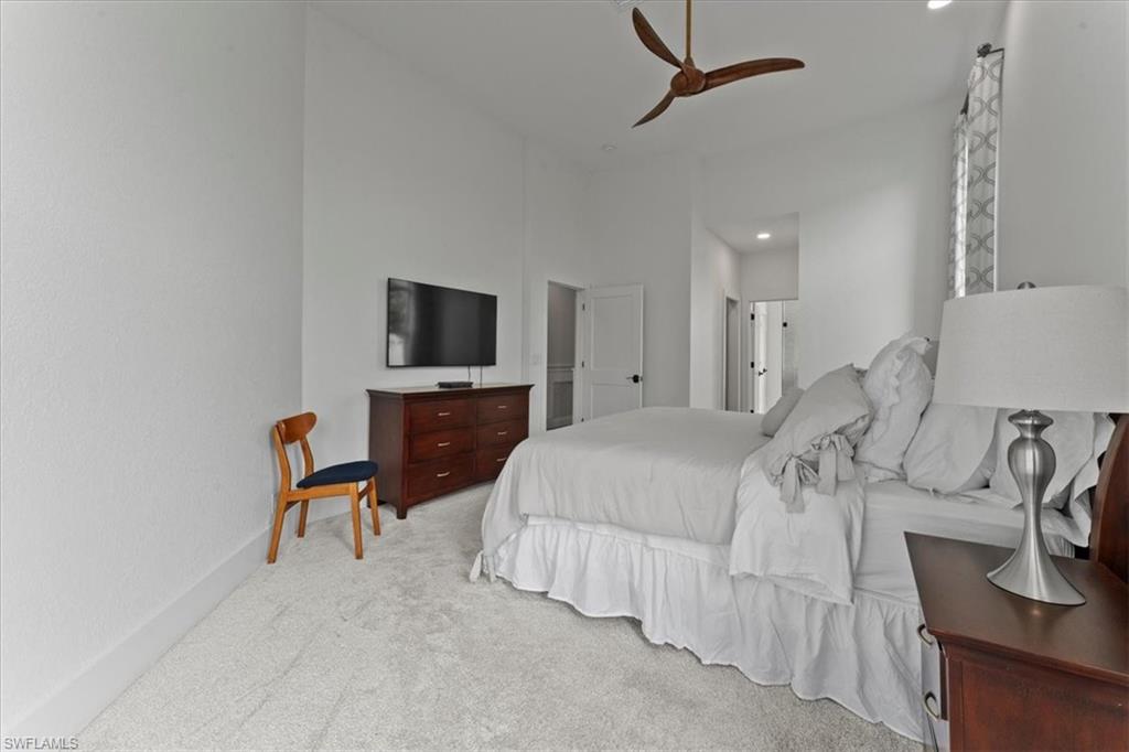 8541 Peppertree Way Naples, FL 34114 - Photo 23 of 41 a spacious bedroom with a bed and a flat screen tv